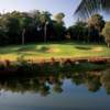 A view over the water of green protected by bunkers from Sugar Cane Course at Plantation Club