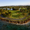 A view of green surrounded by water at West Course from Dorado Beach Resort & Club